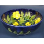 A Moorcroft dark blue ground bowl with buttercup decoration and with impressed marks to base, 16