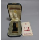 A Dunhill Rollagas pocket cigarette lighter in a black and gilt colourway (cased)