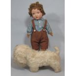 A felt boy doll 1930s, probably by Chad Valley with brown painted eyes, brown mohair wig, swivel