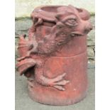 A novel terracotta cylindrical chimney pot with moulded raised mythical winged dragon detail, 50