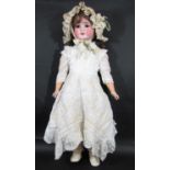 An early 20th century German bisque head doll by Schoenau & Hoffmeister, marked '915 12½' with brown