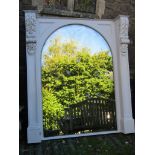 Pair of outsized arched mirrors, the painted frames supporting acanthus bosses, 210 x 180cm