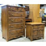 A reproduction bedroom chest of four long and two short graduated drawers with serpentine moulded