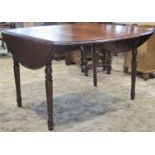 A cherrywood drop leaf extending dining table with moulded outline and single additional leaf raised