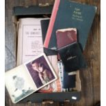 A box containing a wide ranging collection of ephemera to include autograph albums, a quantity of