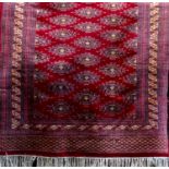 Modern Turkamen Bokhara type rug with typical geometric decoration upon a red ground, 200 x 125cm