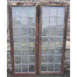 A pair of reclaimed oak framed oak framed windows of rectangular form with pegged joints and