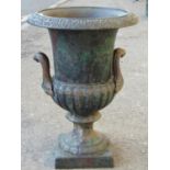 A small reproduction cast iron campana shaped urn with flared rim, lobed body and square base, 32 cm