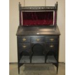 A ladies writing bureau, probably Liberty and Co, the fall flap revealing a fitted interior, the