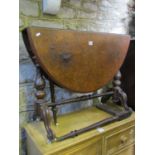 A Victorian walnut oval drop leaf Sutherland tea table with well matched burr and figured veneers,