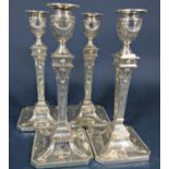 Set of four early 20th century silver Adam style tapered candlesticks on square bases with canted