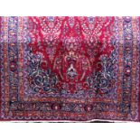 Good quality Persian Mashad carpet with floral pattern on a red ground, 300 x 190 cm