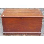 A 19th century stained pine blanket box with hinged lid, side drop carrying handles and exposed