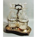 Good quality antique silver plated three decanter bottle cruet, the frame with scrolled acanthus and