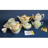 A collection of Crown Ducal sunburst pattern Art Deco teawares including teapot, milk jug, sugar