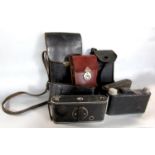 A collection of seven vintage folding cameras