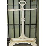 A cast iron two divisional umbrella/stick stand with shaped outline, scrolled foliate detail and