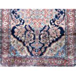 Antique Persian Tabrize type rug with central red floral medallion upon a navy ground 250 x 150 cm