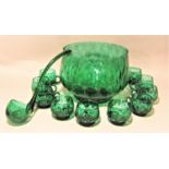 Italian green glass punch bowl ladle and eight cups with geometric bubble decoration, the punch bowl