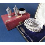 Cased silver scallop shell dish with butter knife, together with a further cased matched three piece