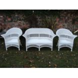A three piece faux wicker garden or conservatory suite comprising a two seat sofa and a pair of