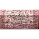 A Belgian wool carpet with Keshan type decoration of floral sprays and red borders upon an ivory