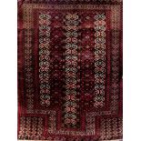 A good quality Turkoman prayer mat with intricate geometric pattern upon a red ground, 130 x 100 cm