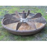 A vintage cast iron Mexican hat shaped pig feeding trough, with unusual revolving fixed segments,