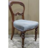 A set of four Victorian mahogany balloon back dining chairs with upholstered seats, raised on turned