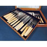 Oak cased canteen of bone handled and silver fish cutlery comprising sixteen knives and forks, maker