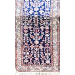 Exceptional long country house Persian runner with geometric floral decoration upon a blue ground,