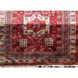 Good quality Turkish carpet with geometric floral decoration upon a red ground, 270 x 205 cm