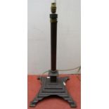 An ironwork lamp standard with reeded column on square cut platform base, 65 cm height