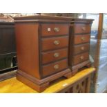 A pair of contemporary, but Georgian style, four drawer bedside chests/lamp tables raised on bracket