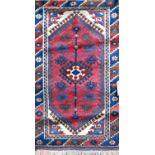 Antique Persian small rug/prayer mat with central medallion decoration upon a red ground, 130 x 75