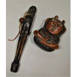 A Betel nut holder in the form of a seated character, a further carved character arms outstretched