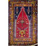 Old Baluchi village prayer mat with central Islamic red medallion fitted with a floral still life