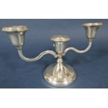 Silver twin branch candelabra upon stepped circular base, 22cm long