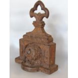 An antique cast iron door porter in the form of a dog in a dog house, 24 cm high