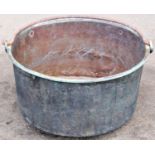 An old copper circular pan, with loose steel loop handle, 46cm diameter x 25cm high