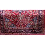 A Persian Tabriz type country house carpet with central blue medallion, further scrolled foliage