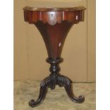 A Victorian rosewood trumpet work box, the circular lid revealing a fitted and segmented interior,