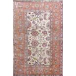 Pale Persian carpet with scrolled floral sprays running orange borders upon an ivory ground, 300 x