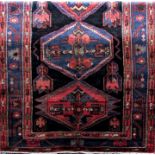 Good quality Zanjan rug with three medallion decoration upon a black ground, 210 x 145 cm