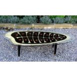 1950s surfboard shaped glass top coffee table, the glass top fitted decorated with a Orla Kiely type