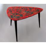 1950s Italian coffee table the red lacquered top with abstract design upon three ebonised tapered