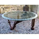 Good quality wrought iron coffee table with two cylindrical legs with ball feet and a further curved