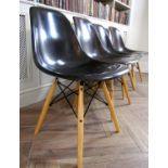 Set of four Eames style Eiffel dining chairs with charcoal fiberglass moulded seats upon four