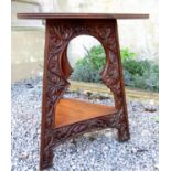 Good quality arts and crafts triangular shaped table with scrolled floral carved sides and under