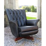 G-Plan swivel lounge chair 'The Most Comfortable Chair in the World', with button back black vinyl